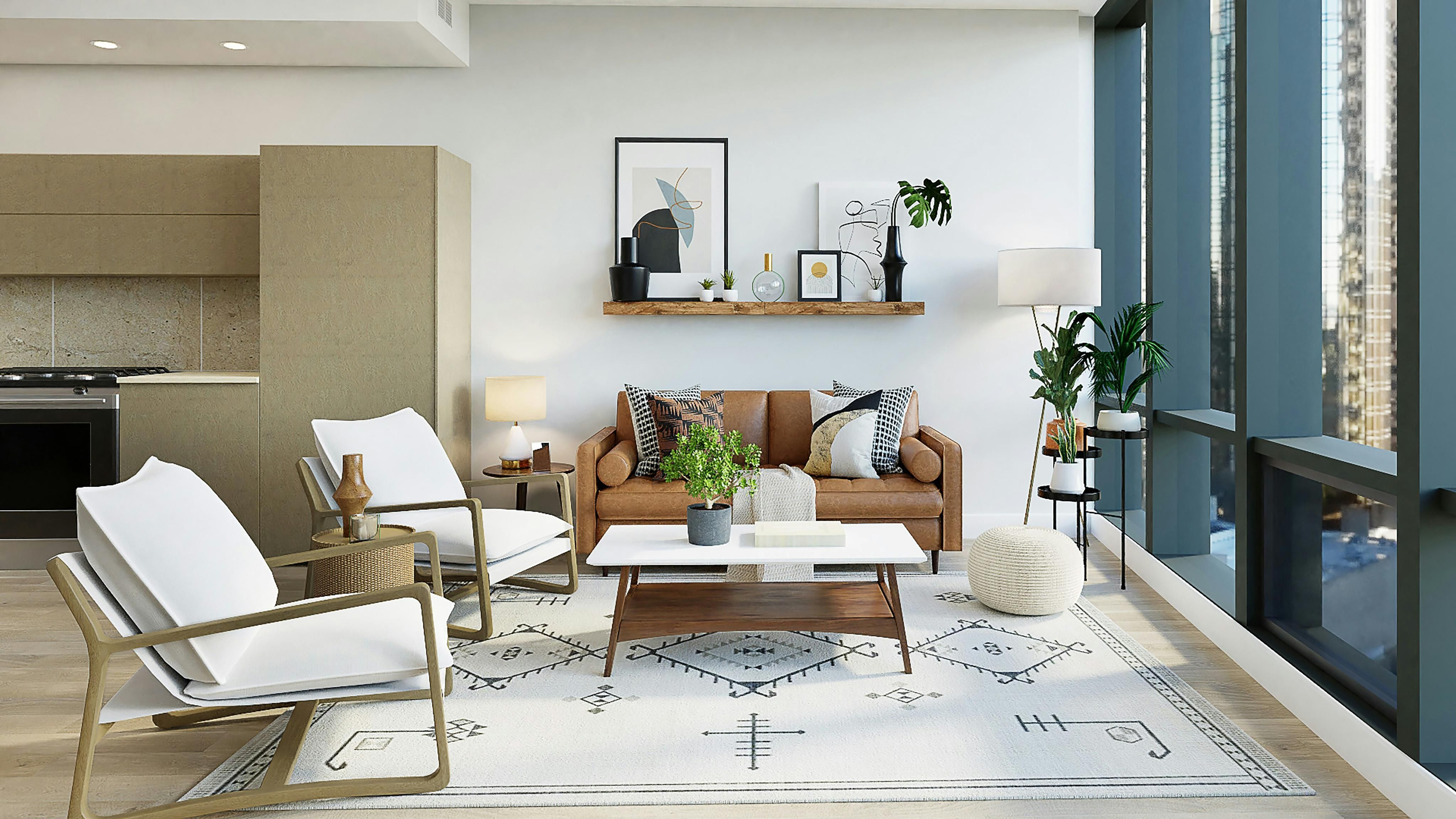 Modern open-concept living room with leather sofa, white chairs, patterned rug, and large windows.