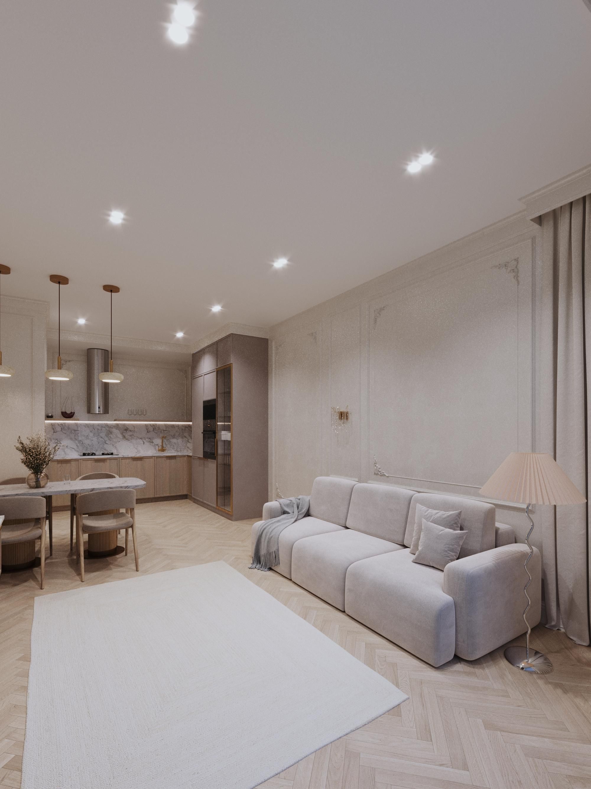 Modern open-plan living room with a light gray sofa, dining area, and kitchen.